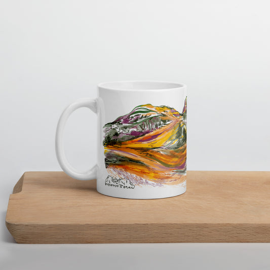 Three Sisters of Glencoe mug displayed on a wooden chopping board