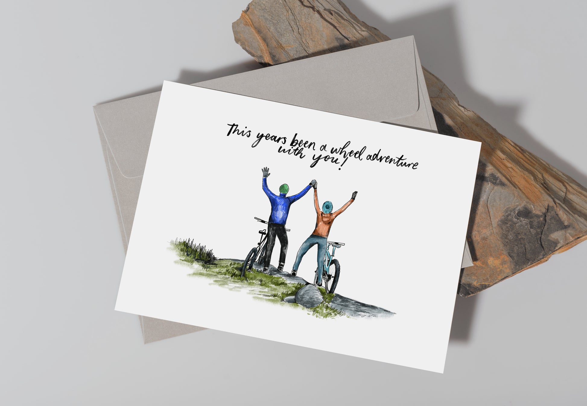 Greetings Card with 2 figures on mountain bikes that reads "This years been a wheel adventure with you!"